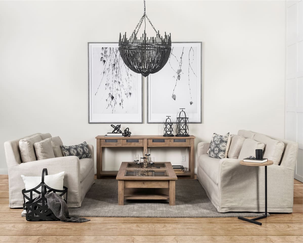 
                Two sofas and black
                hanging iron chandelier
              